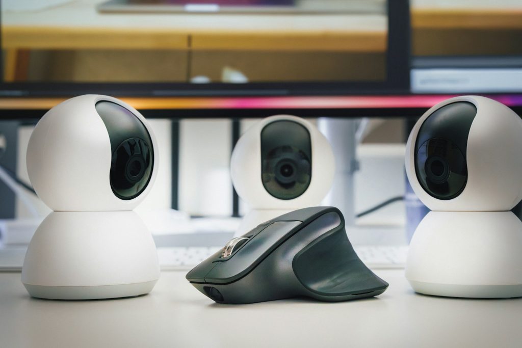 A group of three cameras sitting on top of a table